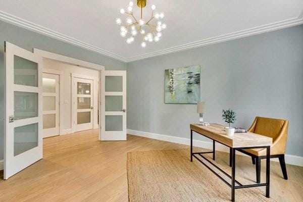 office featuring hardwood / wood-style floors, ornamental molding, french doors, and a chandelier