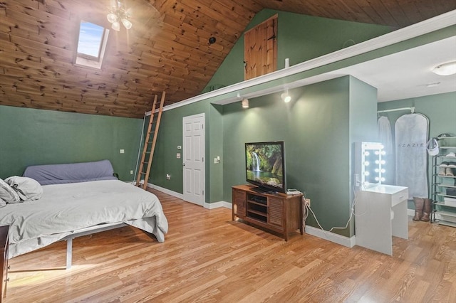 bedroom featuring vaulted ceiling with skylight, wood-type flooring, and wood ceiling