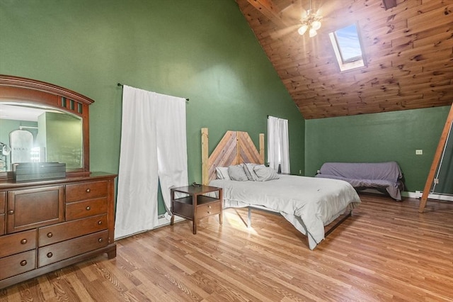 bedroom featuring a skylight, ceiling fan, wooden ceiling, light hardwood / wood-style flooring, and high vaulted ceiling