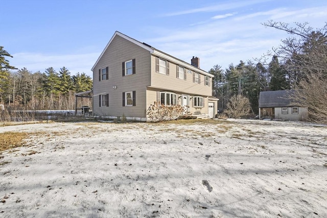 view of side of home featuring an outbuilding