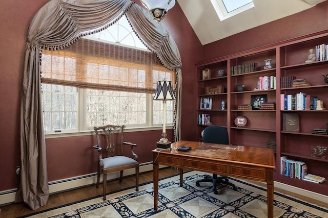 home office with vaulted ceiling with skylight, plenty of natural light, baseboards, and wood finished floors