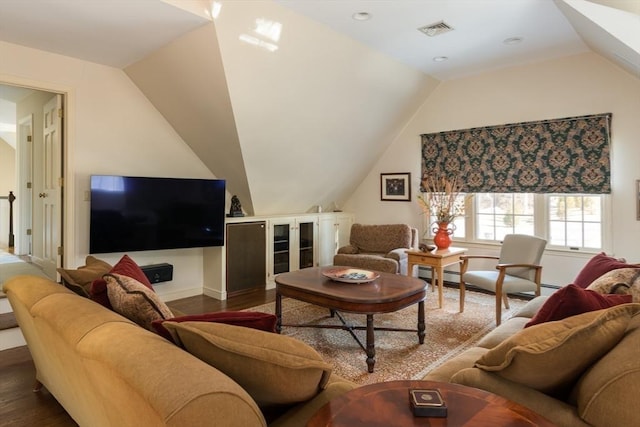 living room featuring visible vents, vaulted ceiling, baseboard heating, and wood finished floors