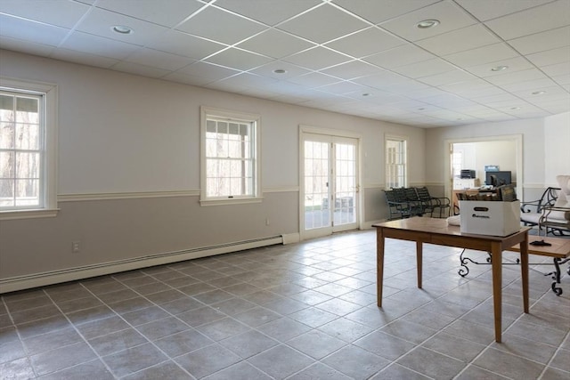 unfurnished office featuring recessed lighting, a baseboard heating unit, a drop ceiling, and tile patterned floors