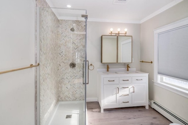 bathroom with crown molding, baseboard heating, walk in shower, and vanity