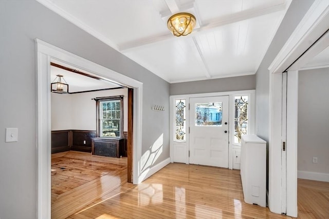 entrance foyer featuring hardwood / wood-style flooring and ornamental molding