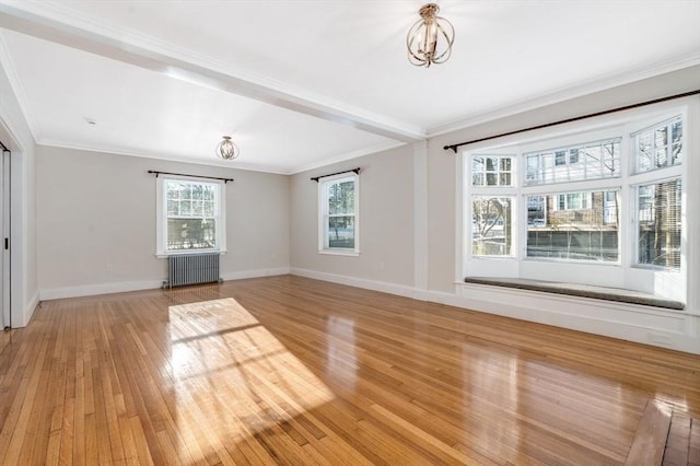 unfurnished living room featuring radiator heating unit, crown molding, a chandelier, and light hardwood / wood-style flooring