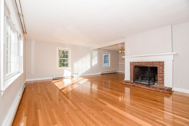 unfurnished living room with a fireplace, wood finished floors, and a baseboard radiator