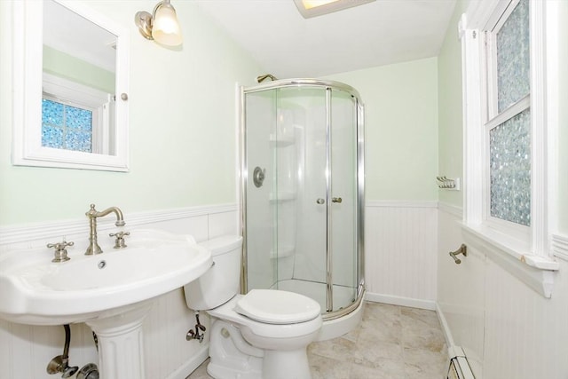 full bath featuring a wainscoted wall, a shower stall, toilet, and a sink