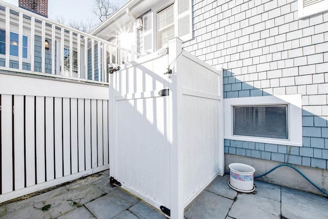 view of side of home featuring fence