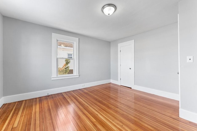 spare room with hardwood / wood-style floors