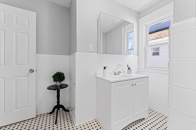 bathroom with vanity and tile walls