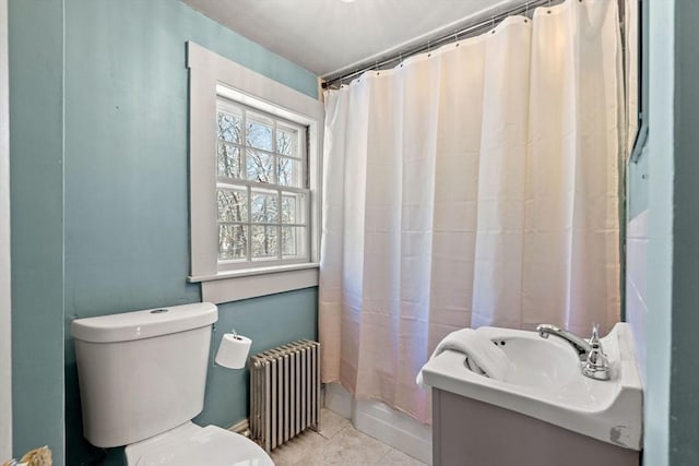 bathroom featuring toilet, radiator, and tile patterned flooring