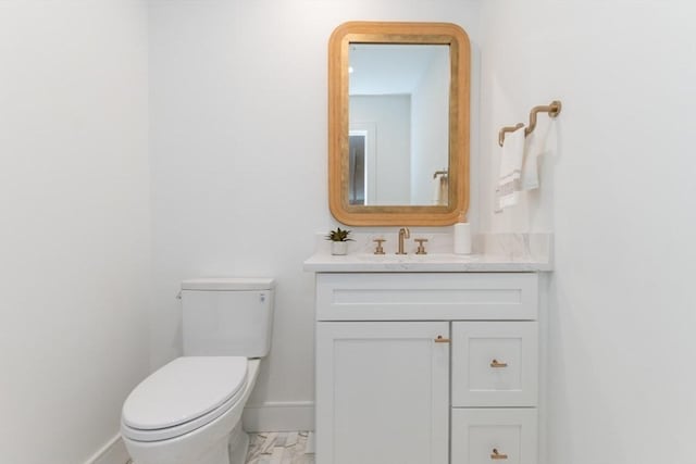 bathroom featuring toilet and vanity