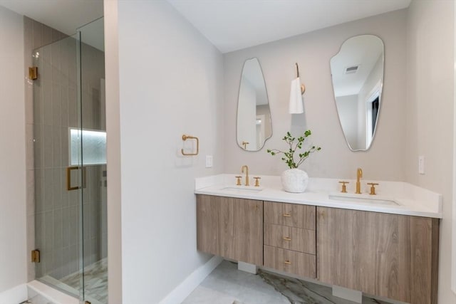 bathroom featuring a shower with shower door and vanity