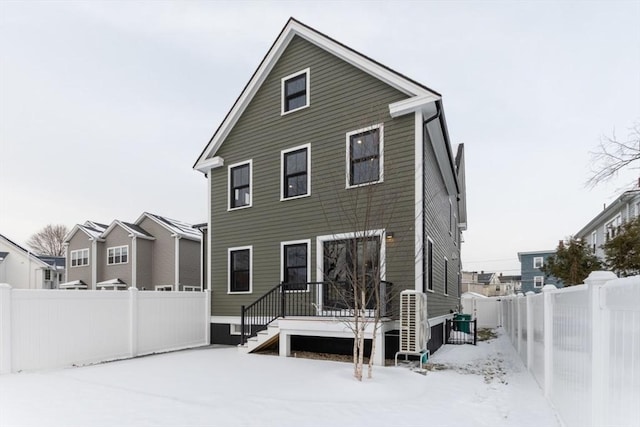 view of snow covered rear of property