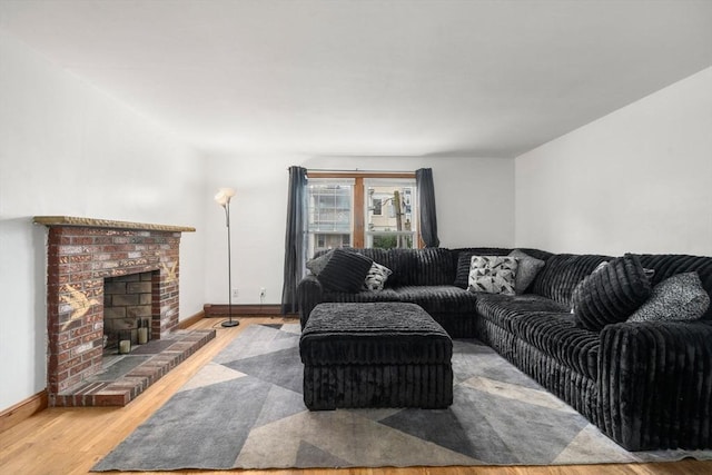 32 Saint Marks Rd Unit 1, Boston, MA 02124 - living room featuring wood finished floors, baseboards, and a brick fireplace