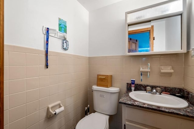 32 Saint Marks Rd Unit 1, Boston, MA 02124 - half bath featuring vanity, toilet, tile walls, and a wainscoted wall