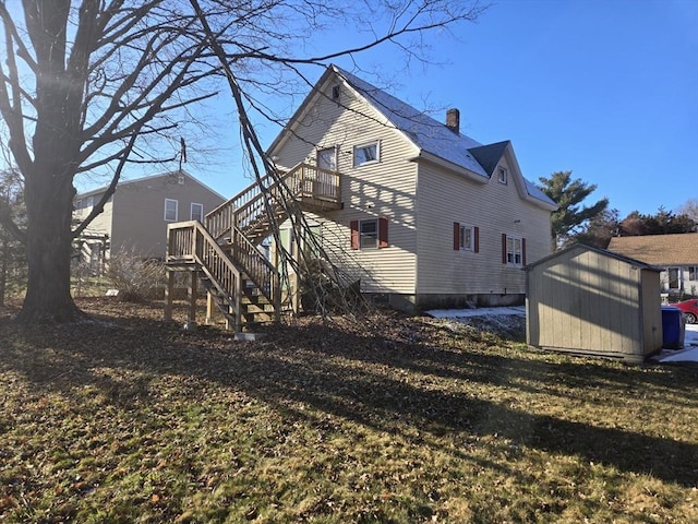 9 Akron Ln, Taunton, MA 02780 - rear view of house with stairs, a storage unit, a chimney, and an outdoor structure
