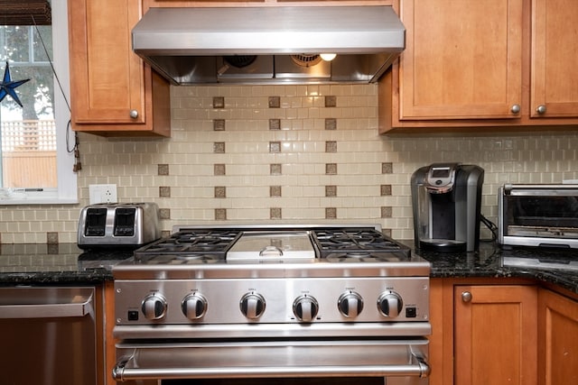 kitchen featuring backsplash, dark stone countertops, ventilation hood, and stainless steel gas range