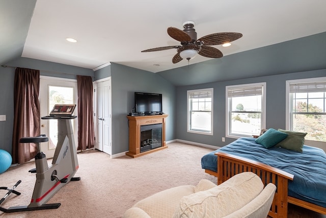 bedroom featuring light carpet, vaulted ceiling, and ceiling fan