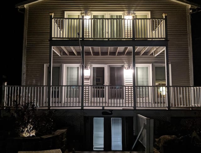 back house at twilight with a balcony