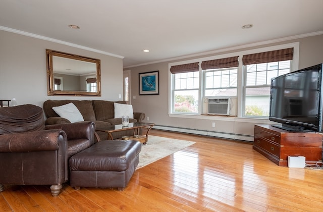 living room with ornamental molding, light hardwood / wood-style floors, and a baseboard heating unit