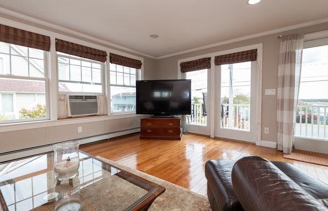 living room featuring ornamental molding, cooling unit, a baseboard radiator, and light hardwood / wood-style flooring