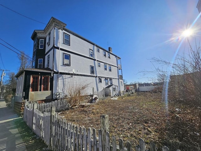 view of side of property featuring fence