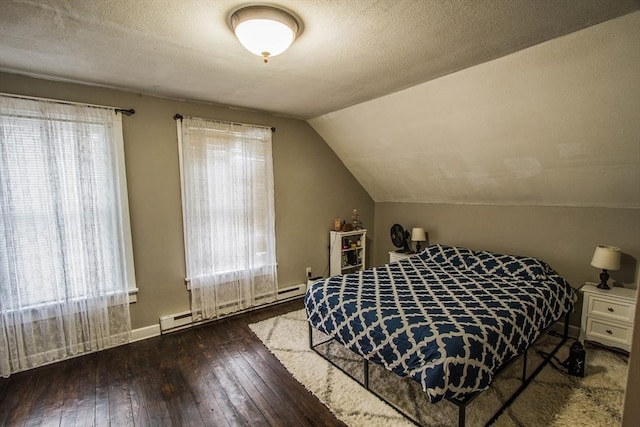 unfurnished bedroom featuring a textured ceiling, lofted ceiling, dark hardwood / wood-style floors, and a baseboard heating unit