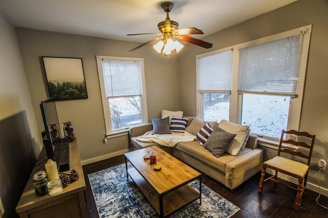 living room with ceiling fan and dark wood-type flooring