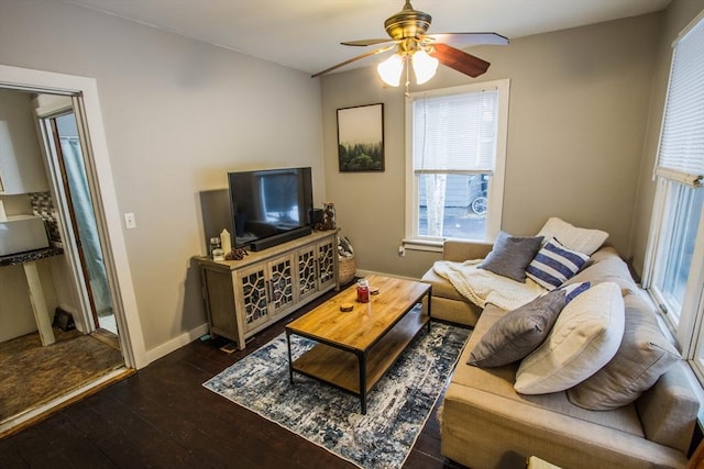 living room featuring ceiling fan and dark hardwood / wood-style flooring