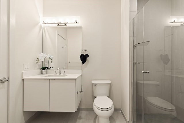 bathroom featuring vanity, toilet, and a shower with door