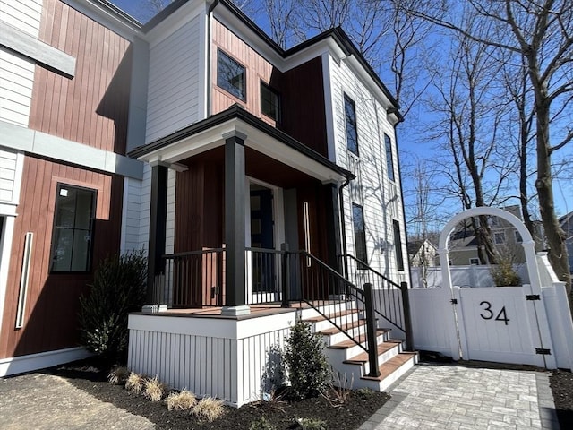 view of home's exterior with a gate and fence