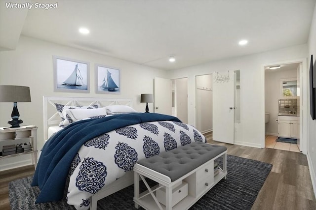 bedroom featuring hardwood / wood-style floors and connected bathroom