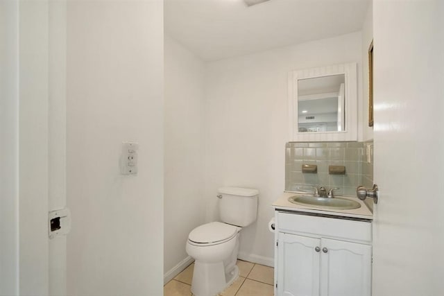 bathroom with toilet, tile patterned flooring, backsplash, and vanity