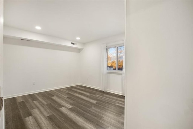 spare room featuring dark hardwood / wood-style floors