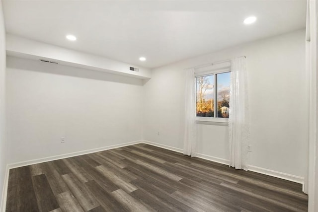 spare room with dark wood-type flooring