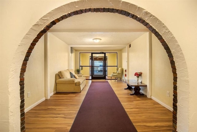 corridor with wood-type flooring