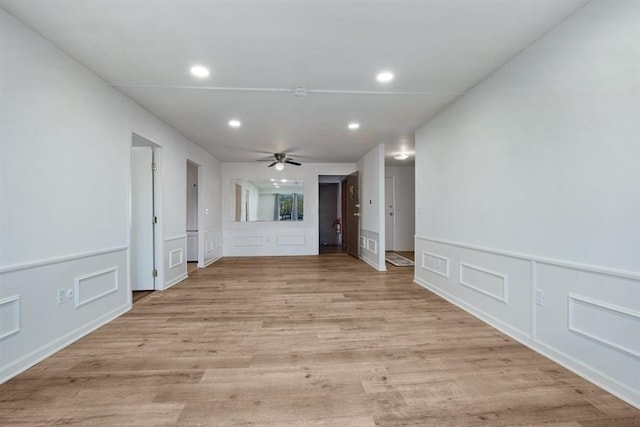 unfurnished living room featuring ceiling fan and light hardwood / wood-style flooring