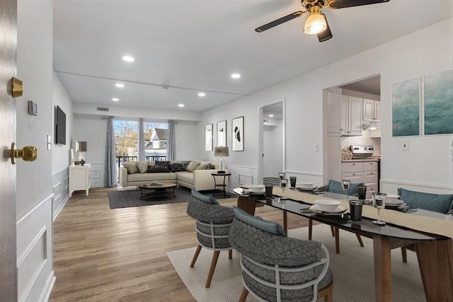 dining room featuring ceiling fan and light hardwood / wood-style flooring