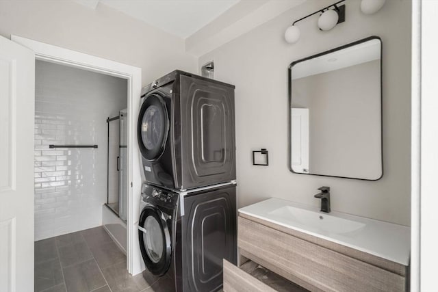 clothes washing area featuring stacked washer / drying machine, a sink, and laundry area