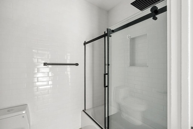 full bathroom with toilet and a shower with shower door