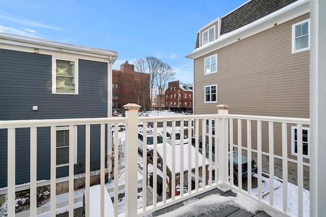 view of snow covered back of property