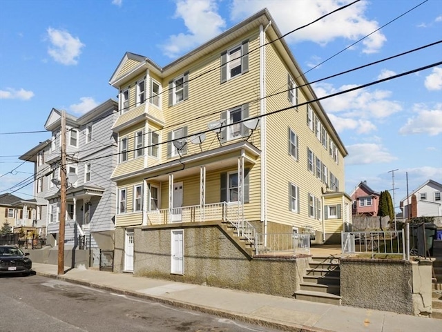 view of property featuring a residential view and stairs