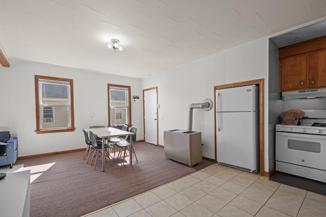 dining space featuring light tile patterned flooring and light colored carpet