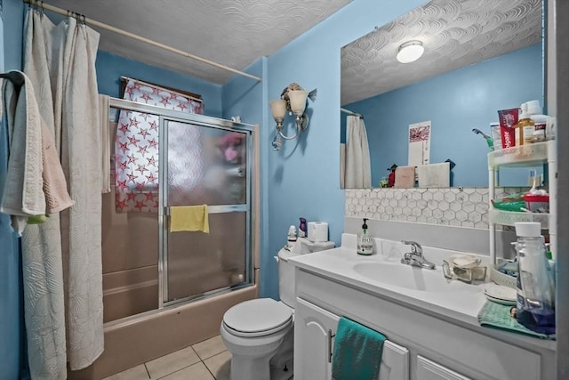 bathroom with tile patterned floors, shower / bath combination with glass door, vanity, and toilet