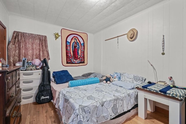 bedroom featuring crown molding and wood finished floors