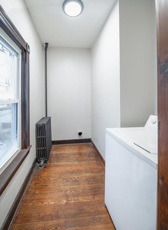 laundry room with laundry area, a healthy amount of sunlight, washer / dryer, and radiator