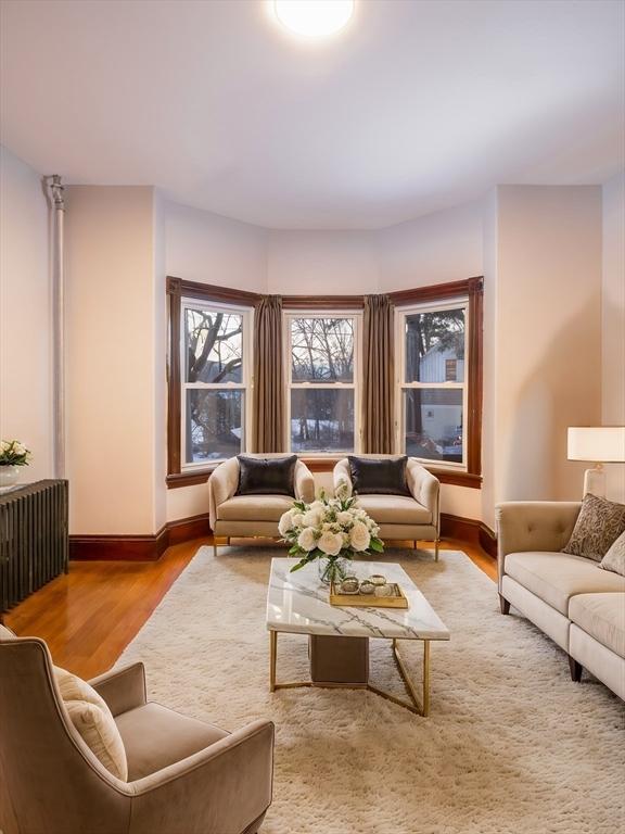 interior space with baseboards, wood finished floors, and radiator