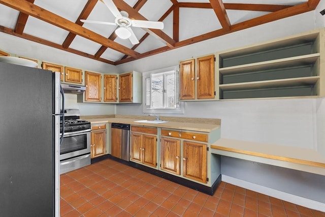 kitchen featuring sink, dark tile patterned floors, ceiling fan, appliances with stainless steel finishes, and vaulted ceiling